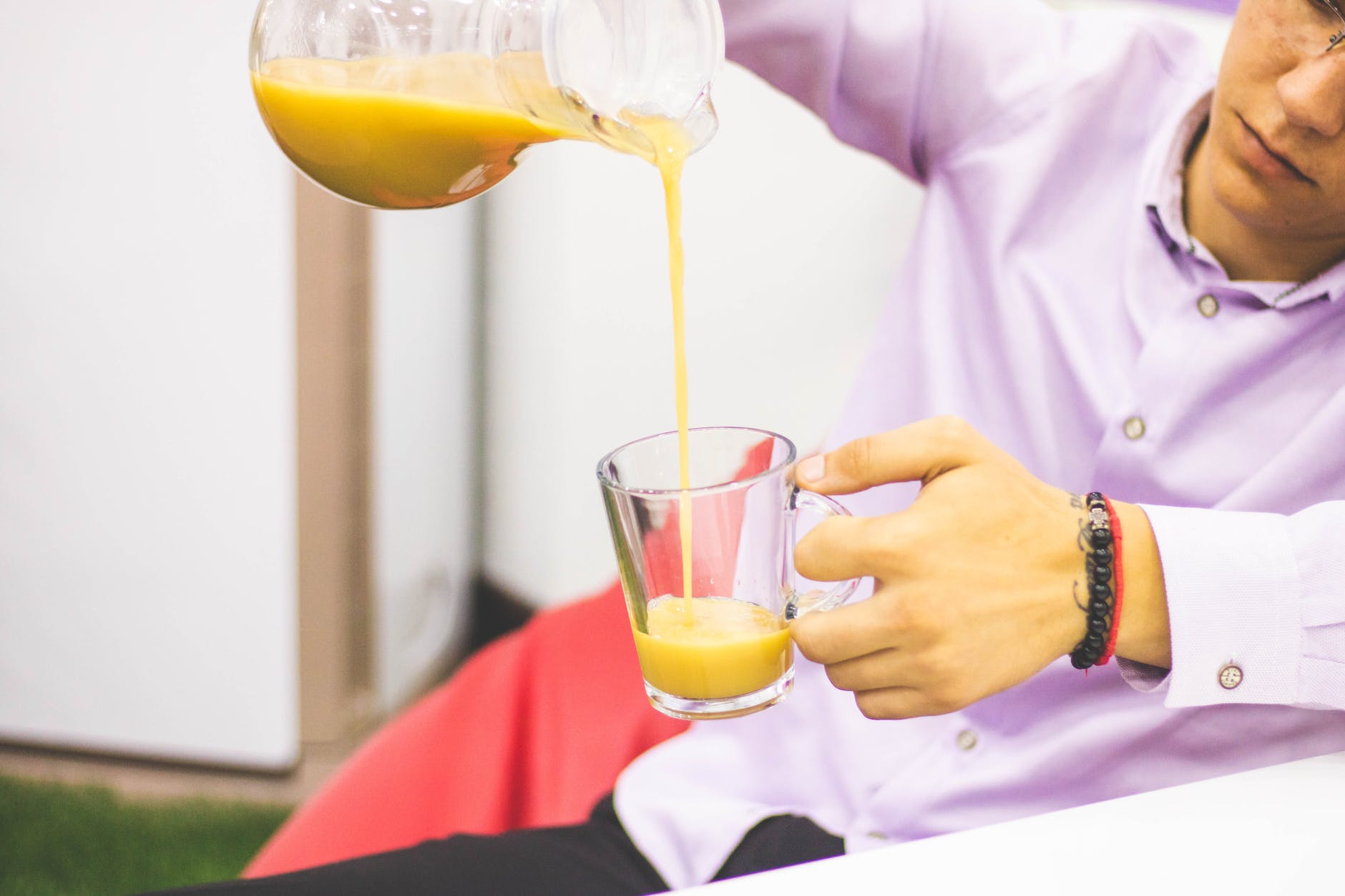 man pours yellow liquid